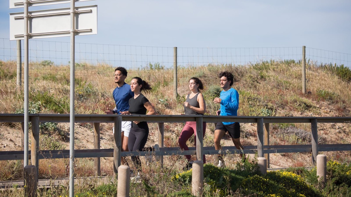 A group of runners jogging together outdoors
